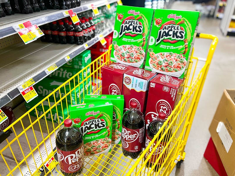 4 boxes of apple jacks, 3 dr pepper 12-packs, and 3 dr pepper 2-liters in a cart