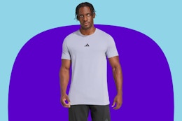 Man wearing an Adidas training shirt on a purple background.