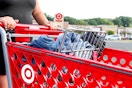 a person pushing a cart full of jeans at target 