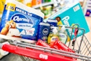 charmin toilet paper, nivea body wash, softsoap hand soap, colgate toothpaste, and pampers diapers in a cart