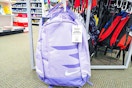 purple nike backpack hanging on a display