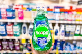 hand holding a bottle of Scope mouthwash