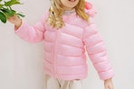 toddler wearing a pink puffer jacket 
