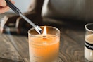 Electric candle lighter lighting candle.