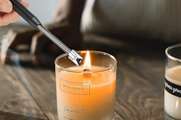 Electric candle lighter lighting candle.
