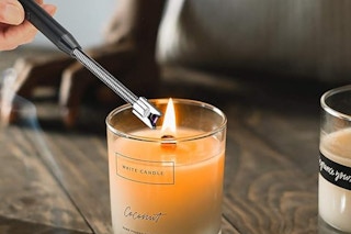 Electric candle lighter lighting candle.