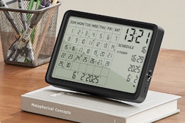 JOOLEEP Desk Calendar sitting on a book on a computer desk.