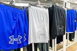 under armour shorts hanging on rack display in store