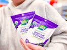 hand holding 2 bags of nature's way sambucus lozenges at target