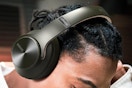 Man wearing over ear Bluetooth headphones.
