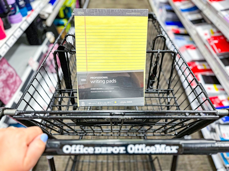 person pushing a cart with professional legal pads in it