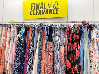 a clearance section sign above a display of dresses
