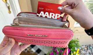 an aarp card coming out of a wallet