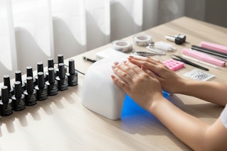 a woman doing her nails at a table