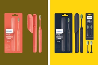 A coral color Sonicare One toothbrush is next to its package. A navy Sonicare One is next to its package and two replacement heads.