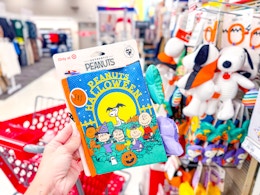 hand holding a peanuts halloween baby book at target