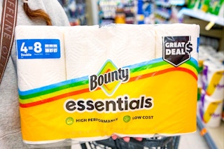 person holding a pack of bounty essentials paper towels