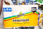 person holding a pack of bounty essentials paper towels