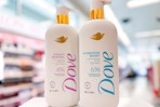 two bottles of Dove serum body wash