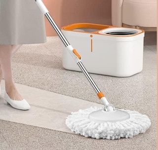 a person mopping the floor with a spin mop