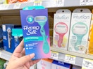 hand holding schick razor and razors on walgreens shelf