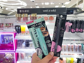 hand holding Wet n Wild makeup in makeup aisle at Target