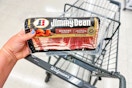 person holding a package of jimmy dean bacon over a walgreens cart