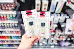 person holding sally hansen hard as nails in front of the display