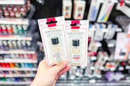 person holding sally hansen hard as nails in front of the display