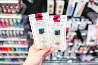 person holding sally hansen hard as nails in front of the display