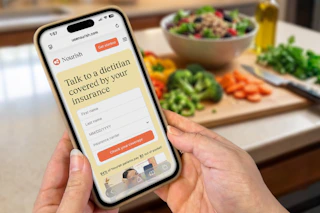 someone looking at the nourish website on their phone while cooking 