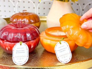 threshold pumpkin candles sitting next to each other