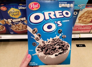 hand holding a box of post cereal