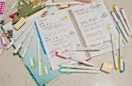 a open notebook with colorful highlighters on top 