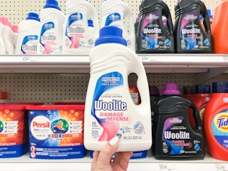 Holding a bottle of Woolite laundry detergent in Target