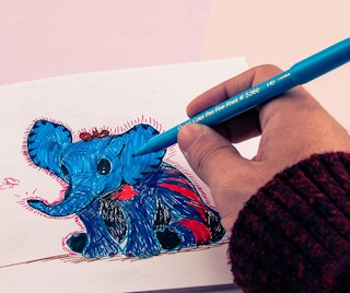 a hand drawing a blue elephant