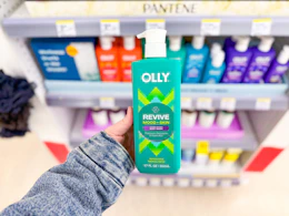 hand holding olly revive body wash in walgreens