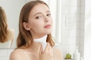 a woman holding a facial massager