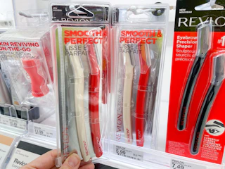 A revlon facial defuse held out by hand next to another Revlon facial defuzzer.