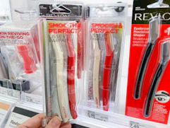 A revlon facial defuse held out by hand next to another Revlon facial defuzzer.