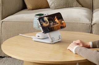Woman using the PaktVault 2025 Traveling Fast Wireless Charging Station on her coffee table.