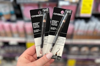 hand holding two covergirl eyeliners