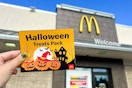 someone holding the halloween treats pack outside of mcdonalds