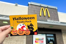someone holding the halloween treats pack outside of mcdonalds