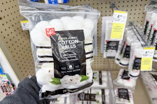 person holding a bag of cotton balls