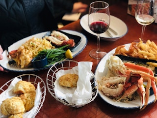 Full table spread at red lobster of crab, lobster steak, and biscuits