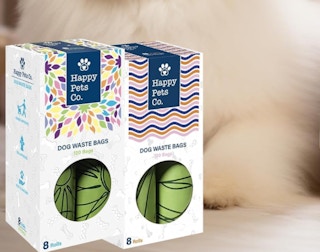 two boxes of rolled up green bags next to each other