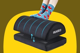 User with their feet on an office foot rest.
