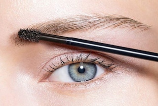 a person putting on brow makeup