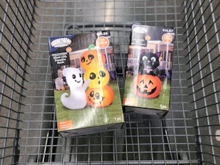 inflatable halloween decor in boxes in Walmart shopping cart